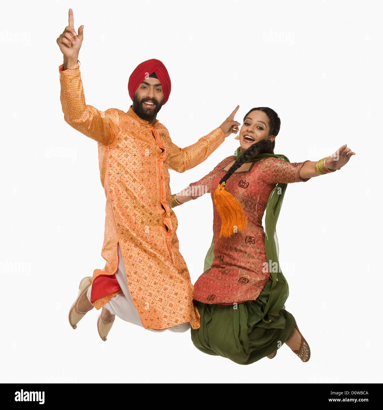Sikh couple doing Bhangra the folk dance of Punjab in India Stock ...