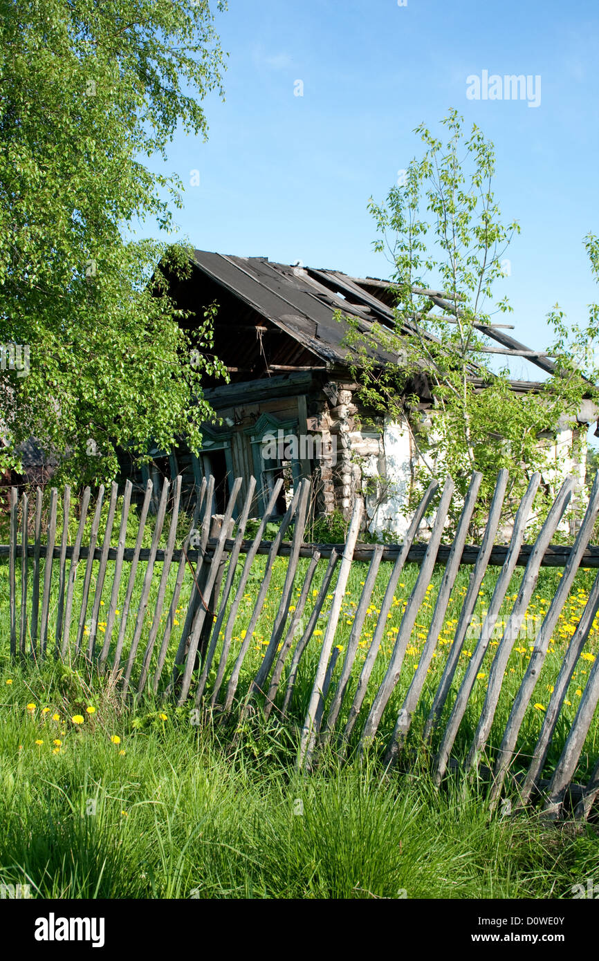 The thrown house and the lop-sided fence Stock Photo