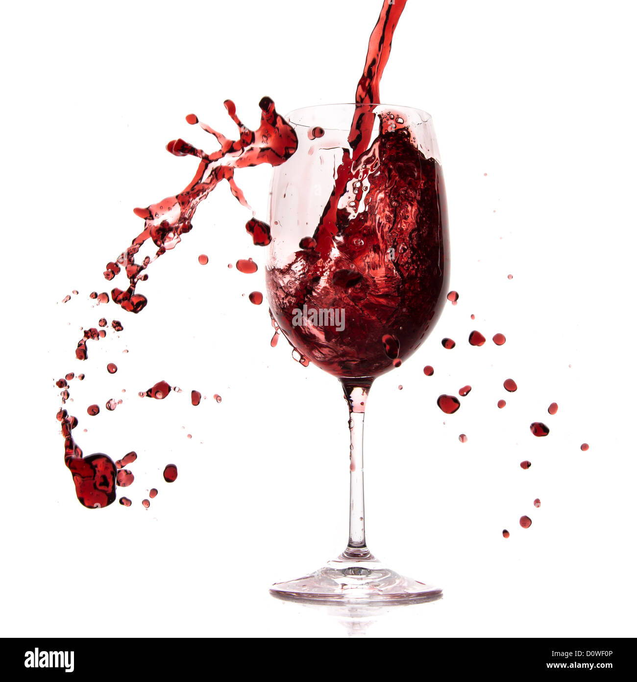 pouring red wine in goblet, isolated on white Stock Photo