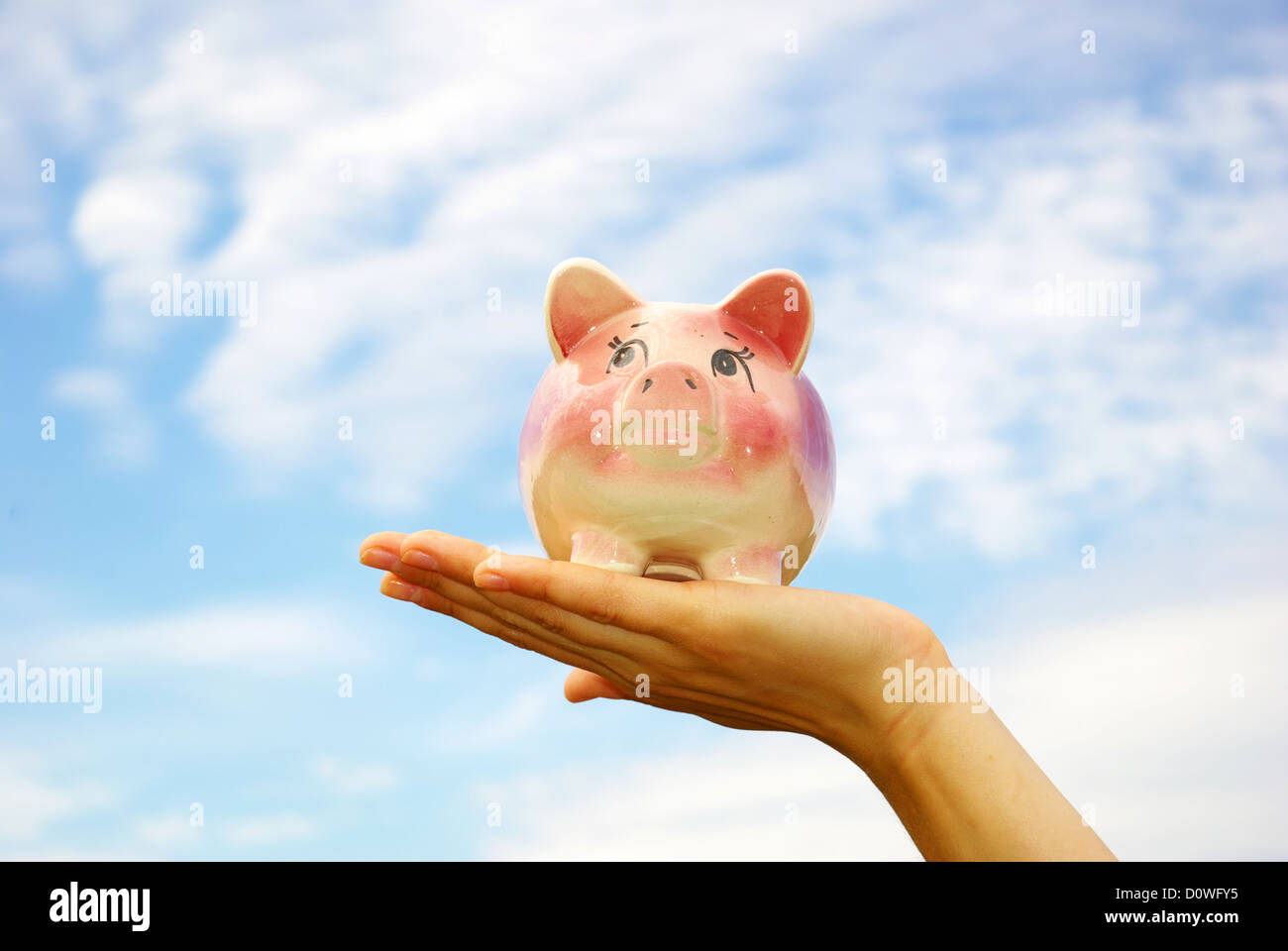 saving money woman hands holding piggy bank Stock Photo