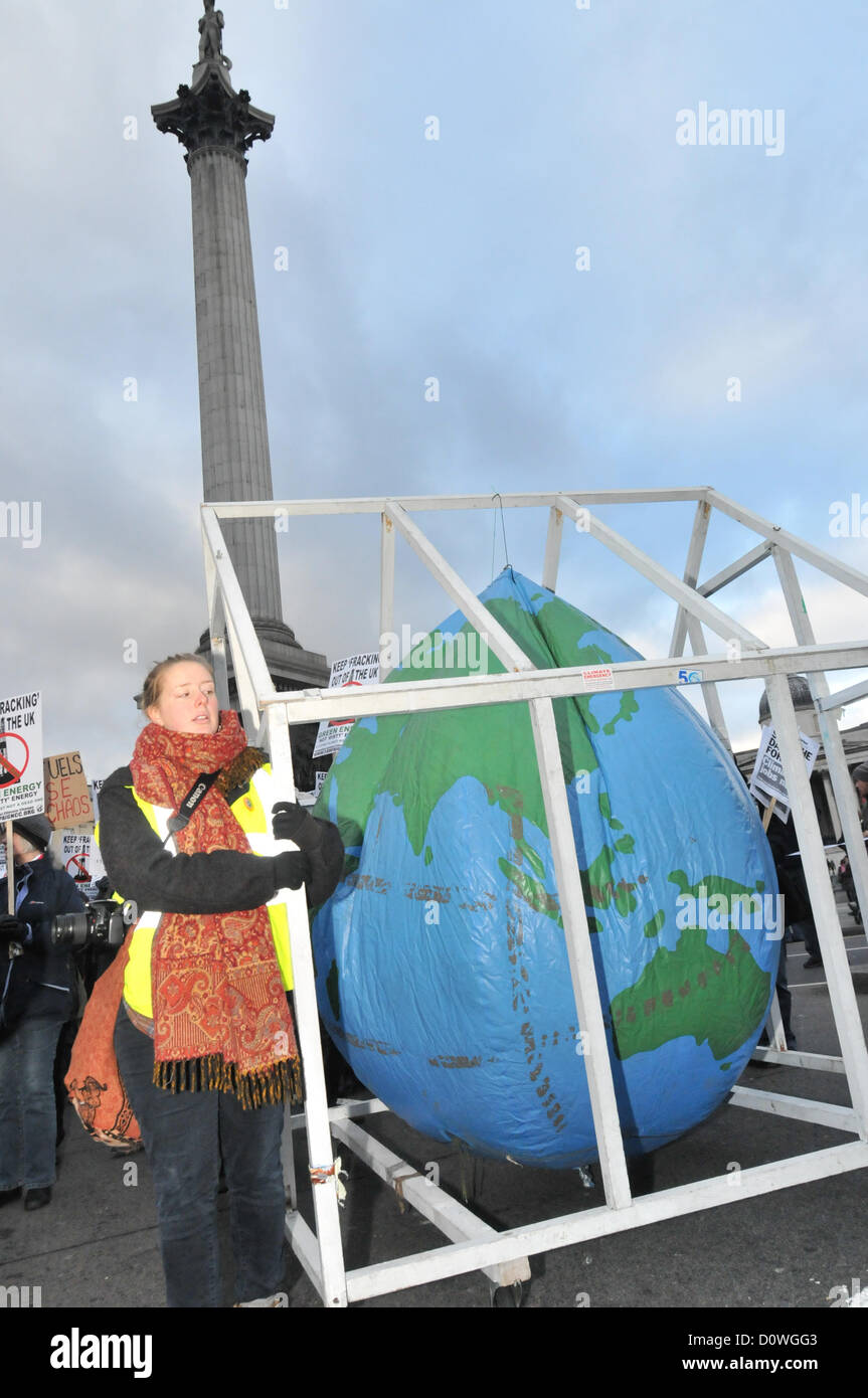 Trafalgar Square, London, UK. 1st December 2012. Protesters with an Earth balloon in a Greenhouse march opposite Trafalgar Square carrying banners and placards. The Campaign Against Climate Change group march on Parliament Square and build a 'Fracking Rig' as a protest against the practice of Hydraulic Fracturing to mine for shale gas and its potential harm to the environment. Credit:  Matthew Chattle / Alamy Live News Stock Photo