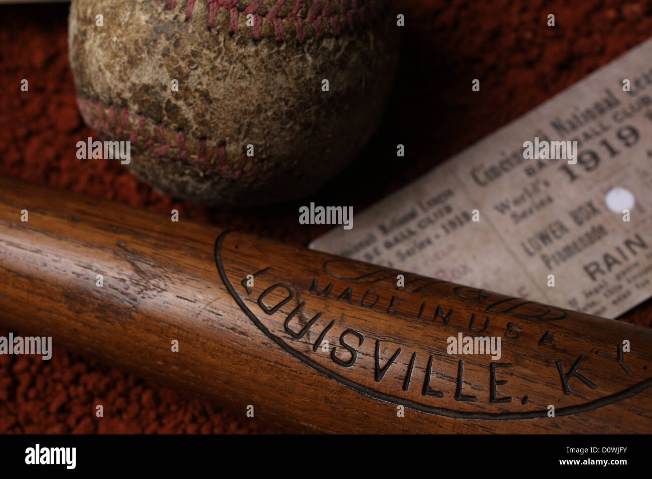 An antique vintage baseball, baseball bat, and used ticket stub. Stock Photo
