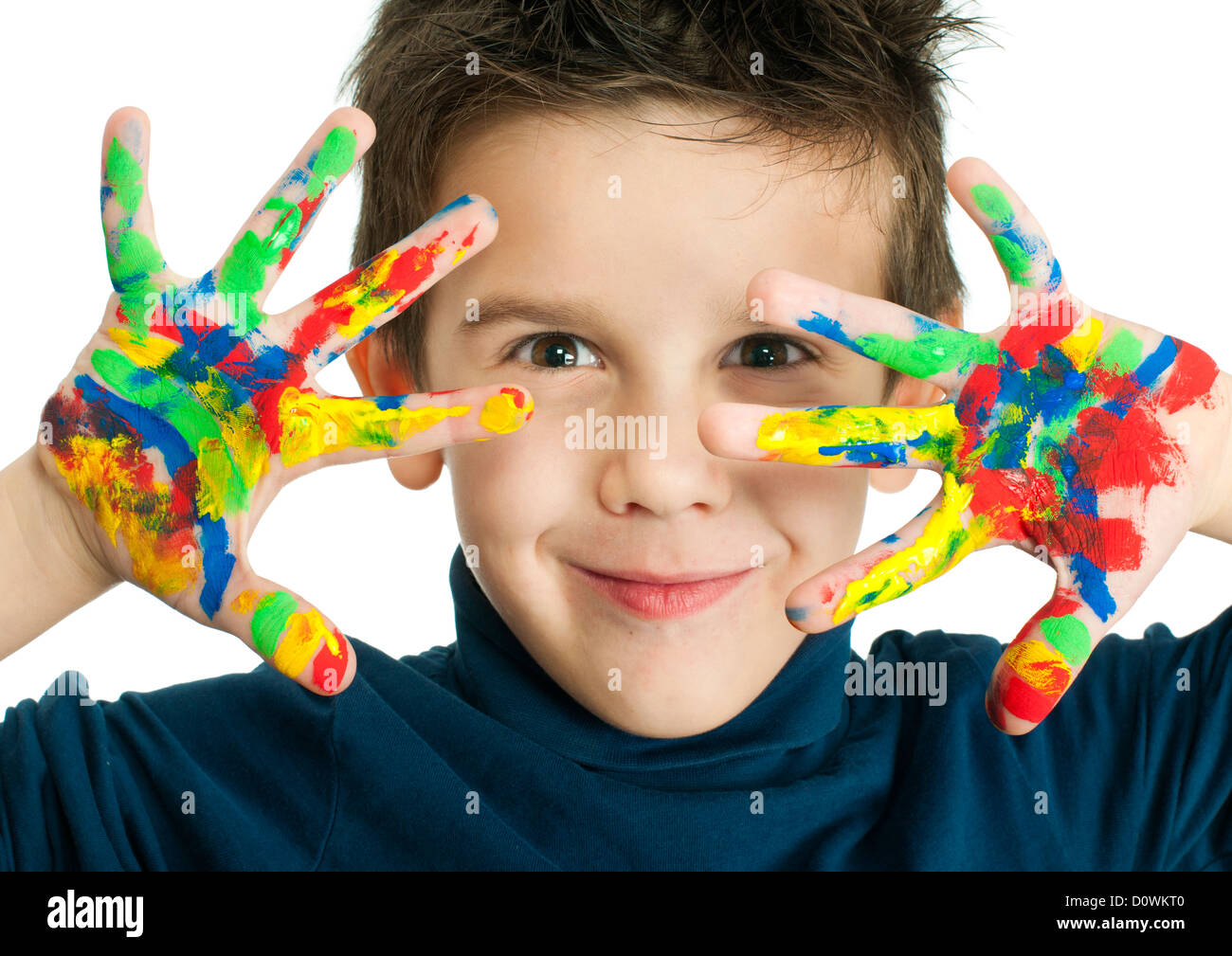 Boy hands painted with colorful paint. White islated smiling child Stock Photo