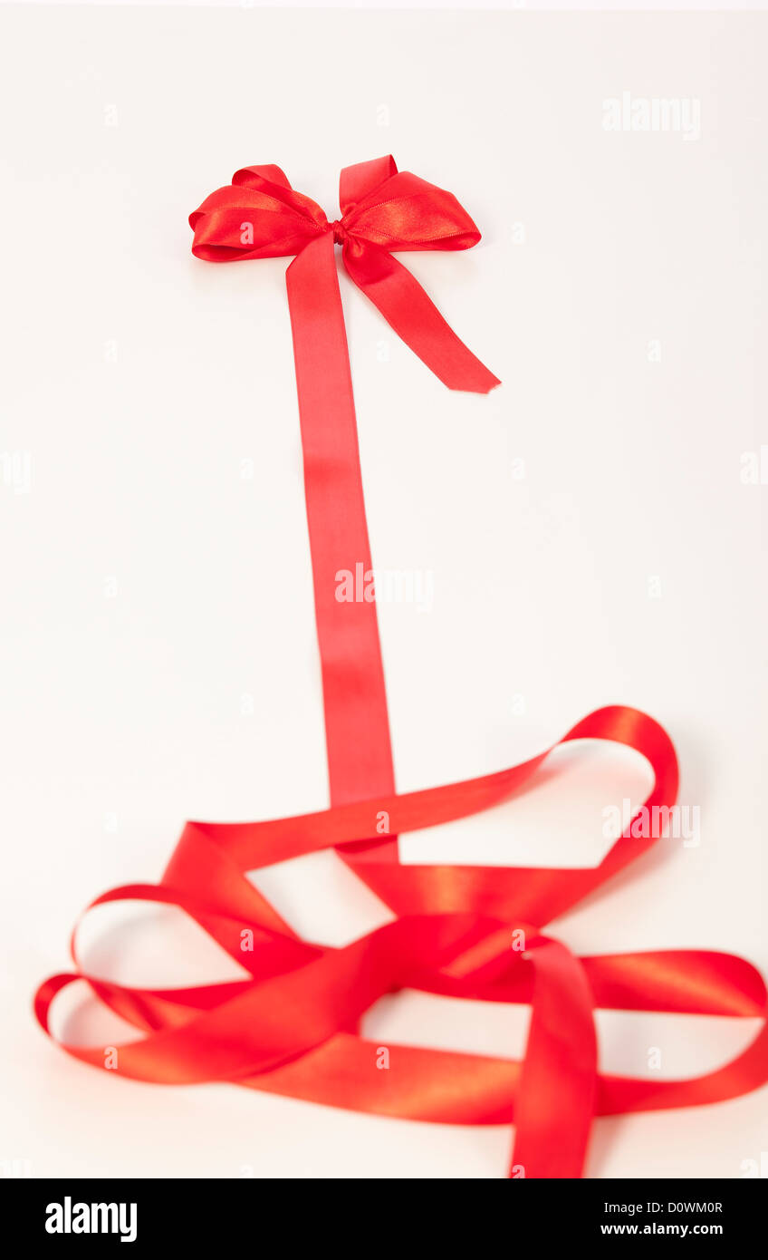 Shiny red satin ribbon on white background Stock Photo - Alamy