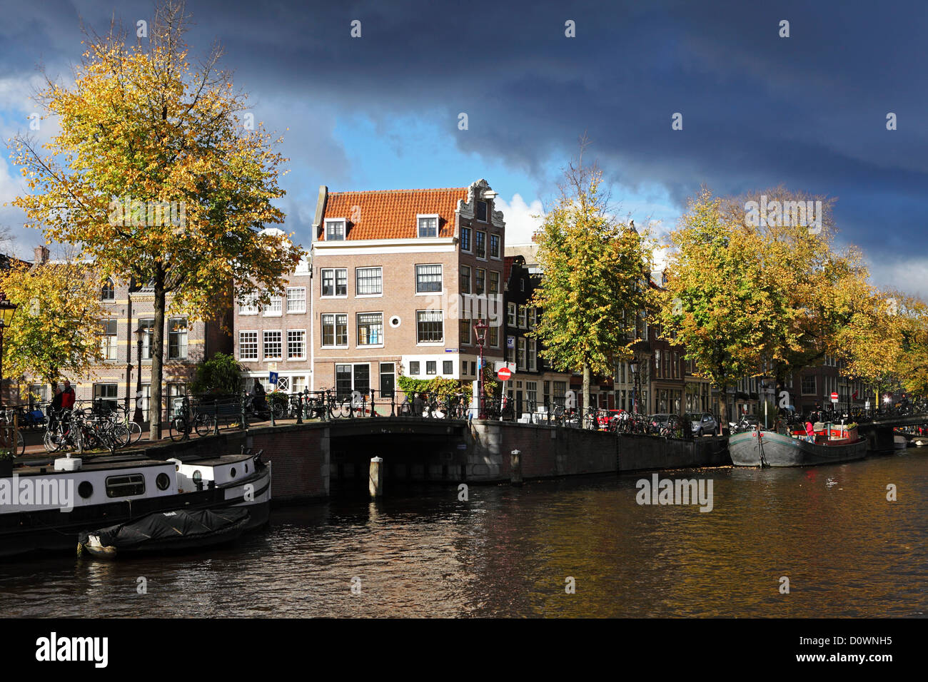 Clouds gather over a canal on the Negen Straatjes (Nine Streets) district of Amsterdam, Holland, the Netherlands. Stock Photo