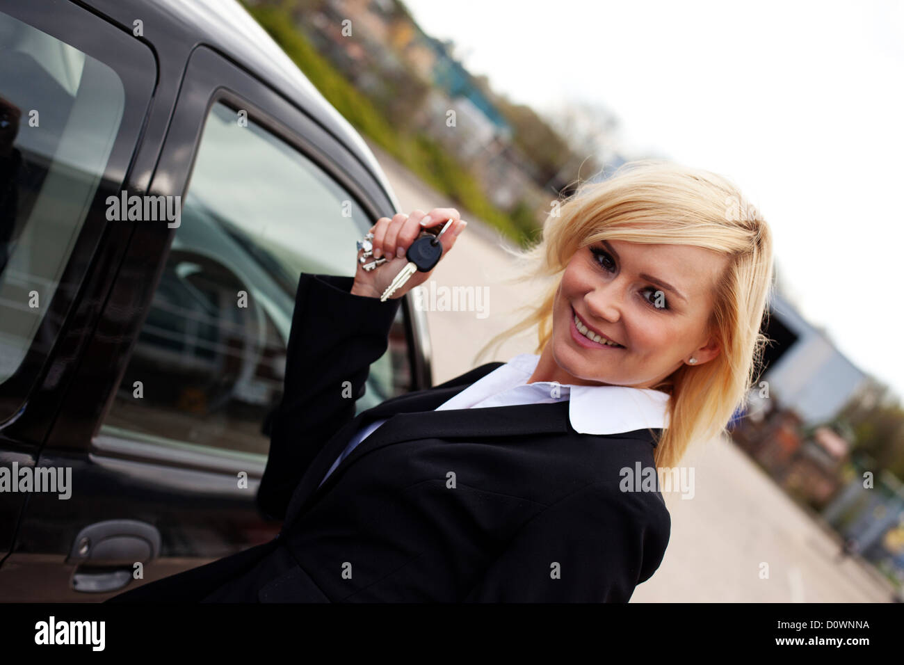 Young blonde woman holding keys hi-res stock photography and images - Alamy
