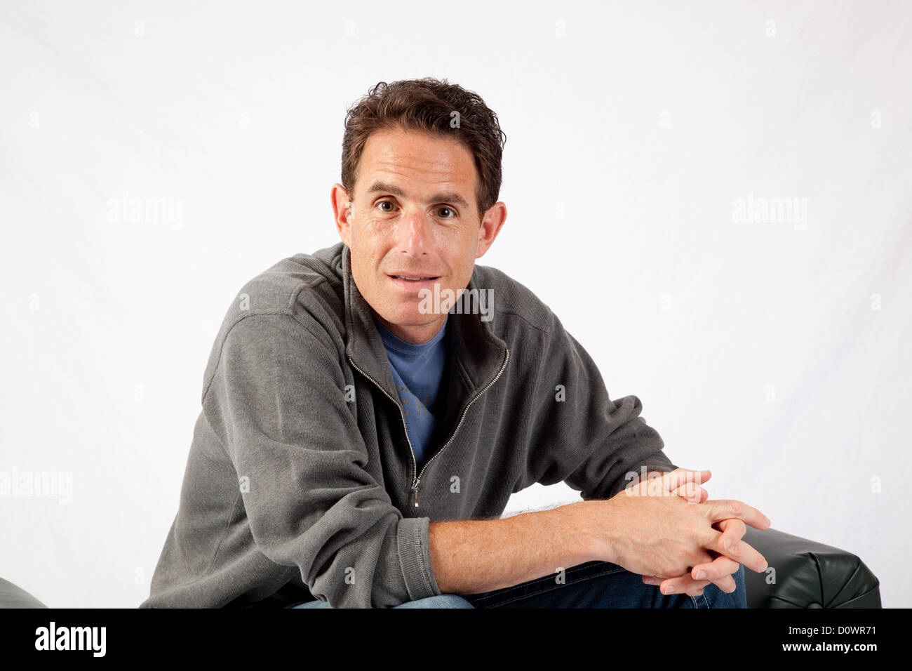 Man sitting elbows on knees hi-res stock photography and images - Alamy