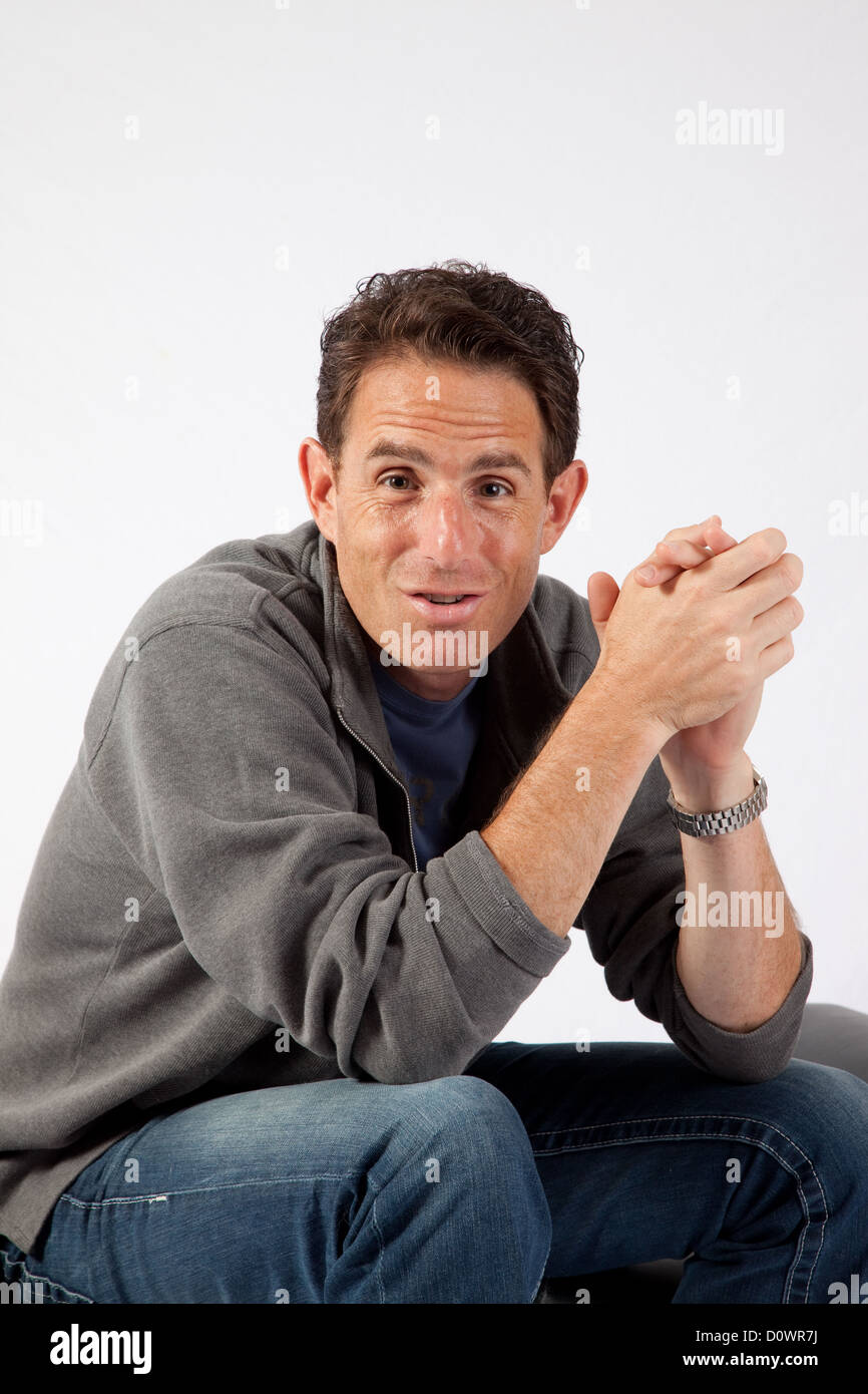 Man sitting elbows on knees hi-res stock photography and images - Alamy