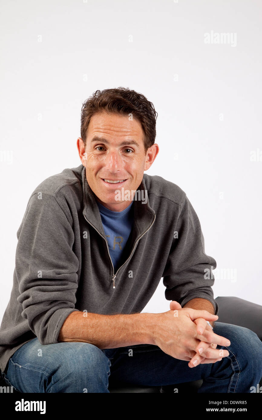 Man sitting elbows on knees hi-res stock photography and images - Alamy