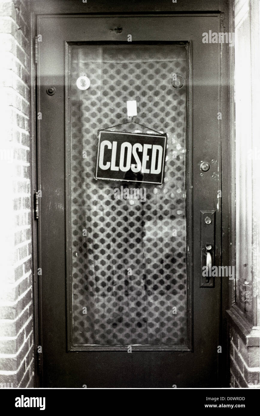 A Closed Sign Hangs From A Store Front Door In Astoria
