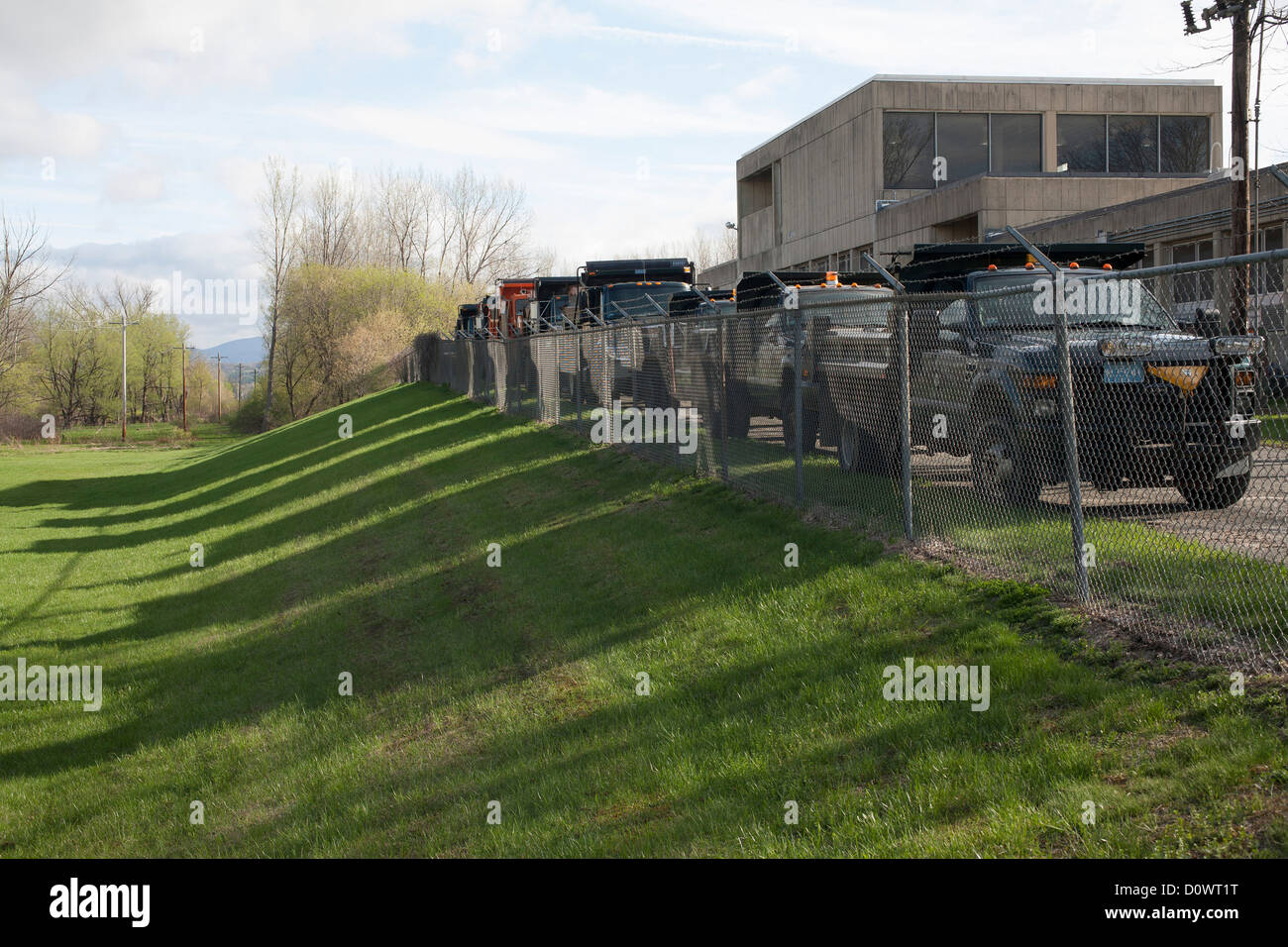 Municipal dump trucks line up at the town Wastewater Treatment Plant in