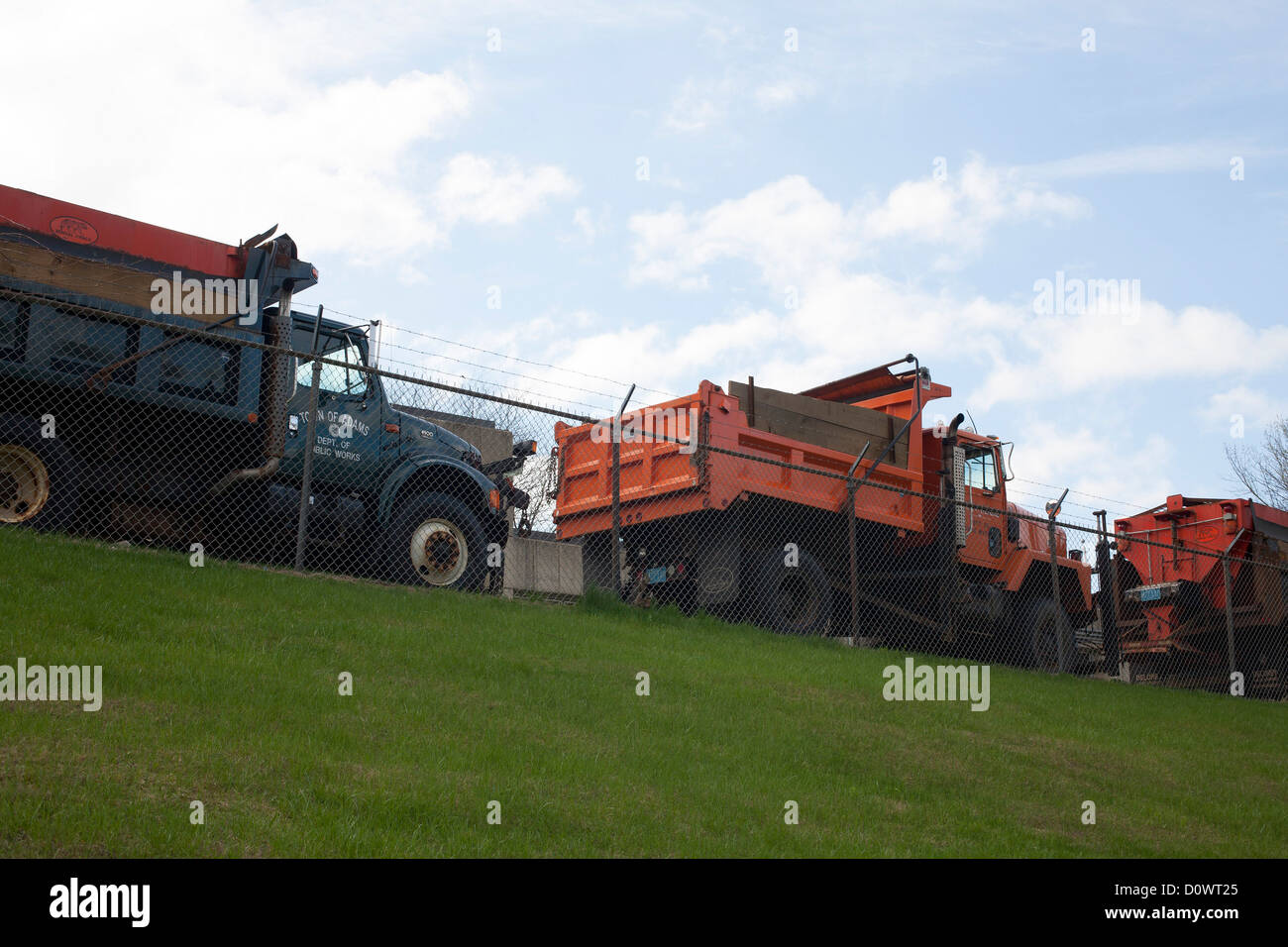 Municipal dump trucks line up at the town Wastewater Treatment Plant in