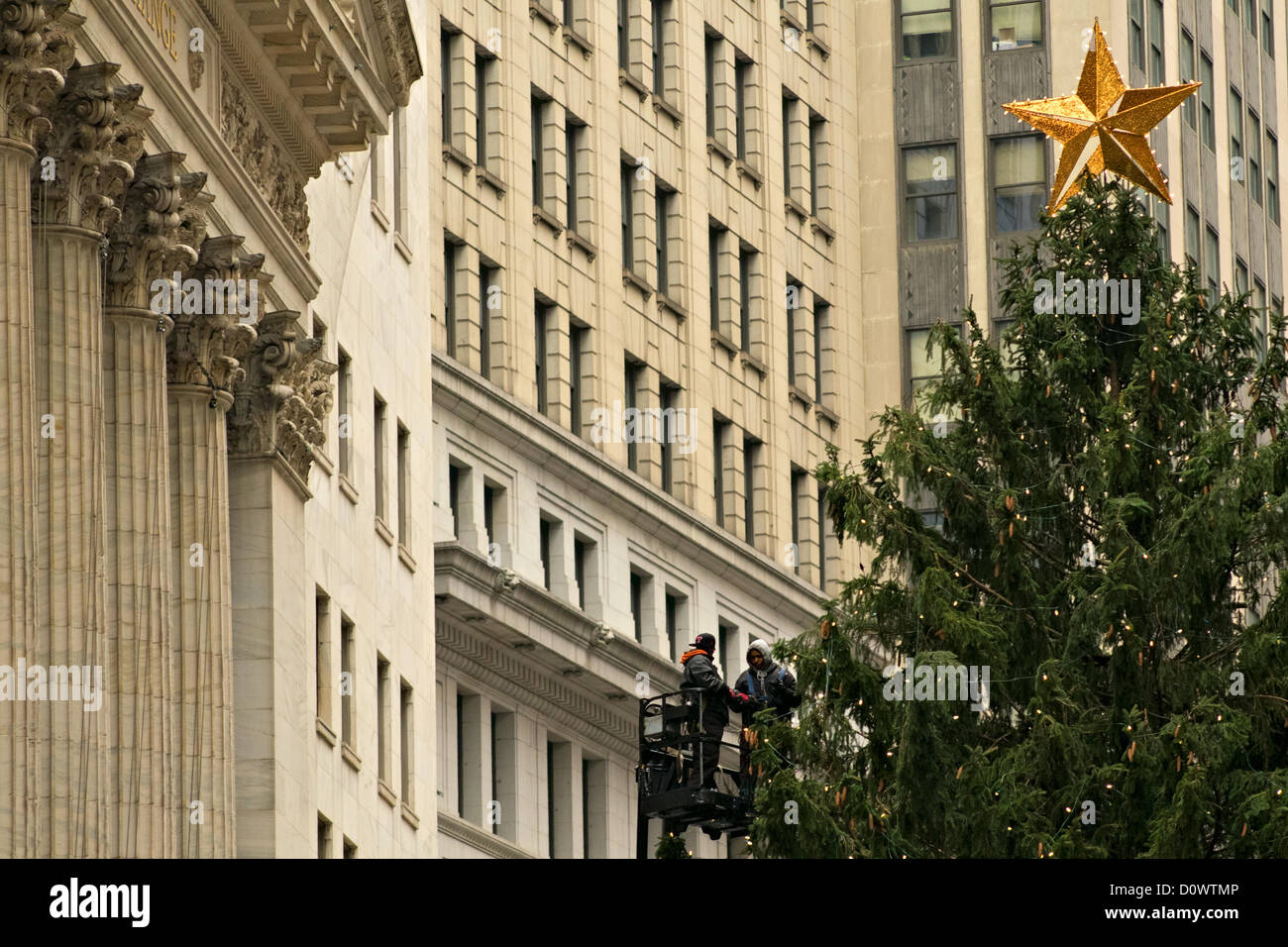 December 1, 2012, New York, NY.  Workers string lights on Christmas tree outside New York Stock Exchange to prepare for lighting ceremony on December 4. Stock Photo