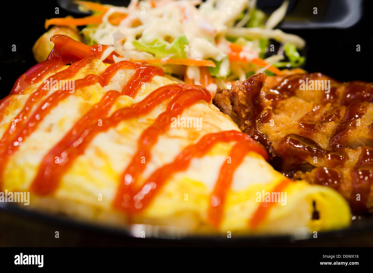 pork flavoured rice wrapped with fried egg and special sauce Stock