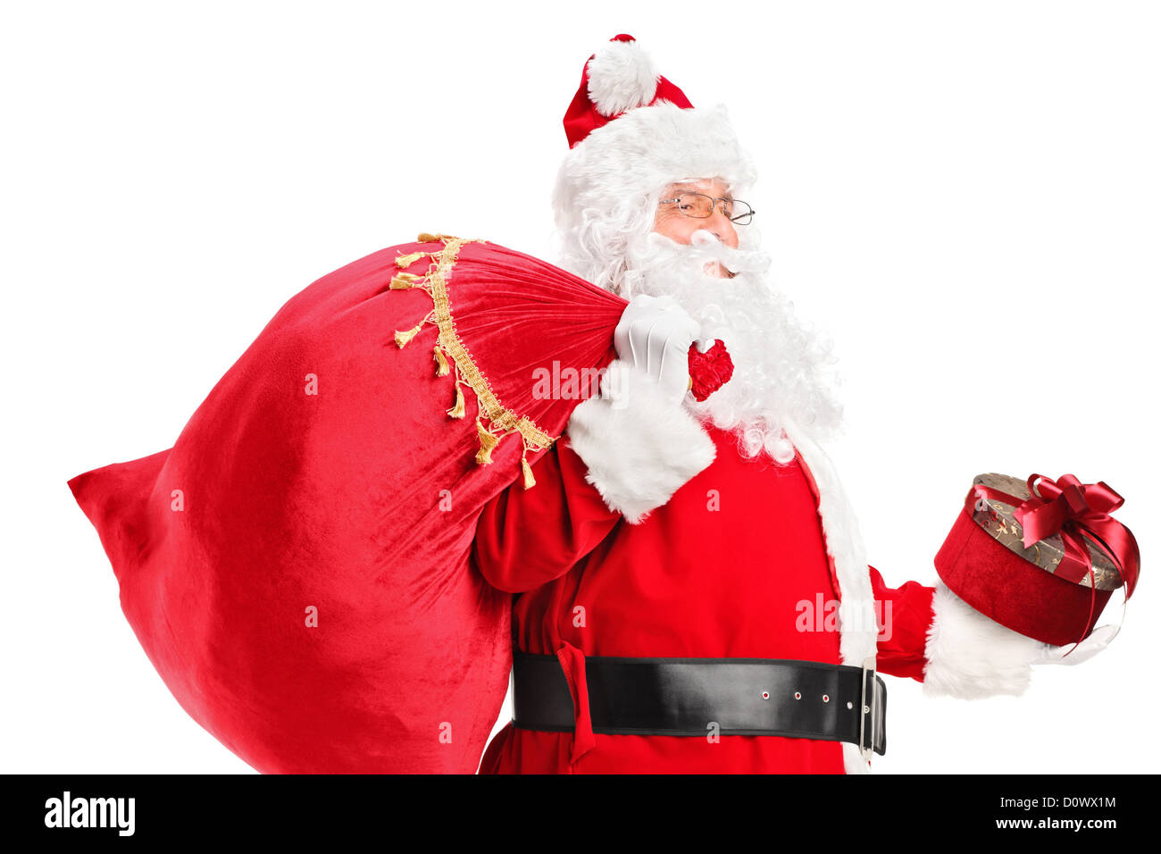 A Santa Claus carrying a bag full of gifts on his back isolated on ...