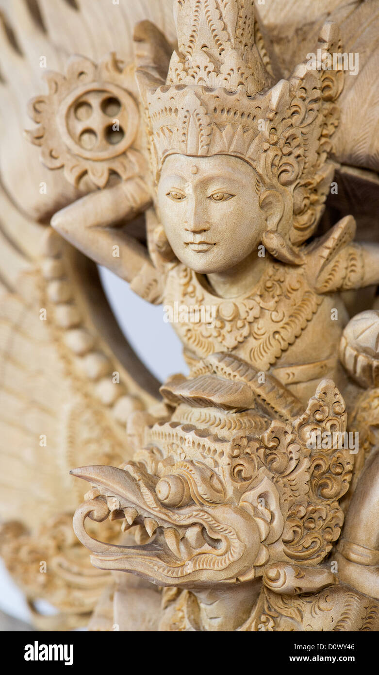 Hand carved Vishnu, Garuda, Nagas wooden statue from Bali on white