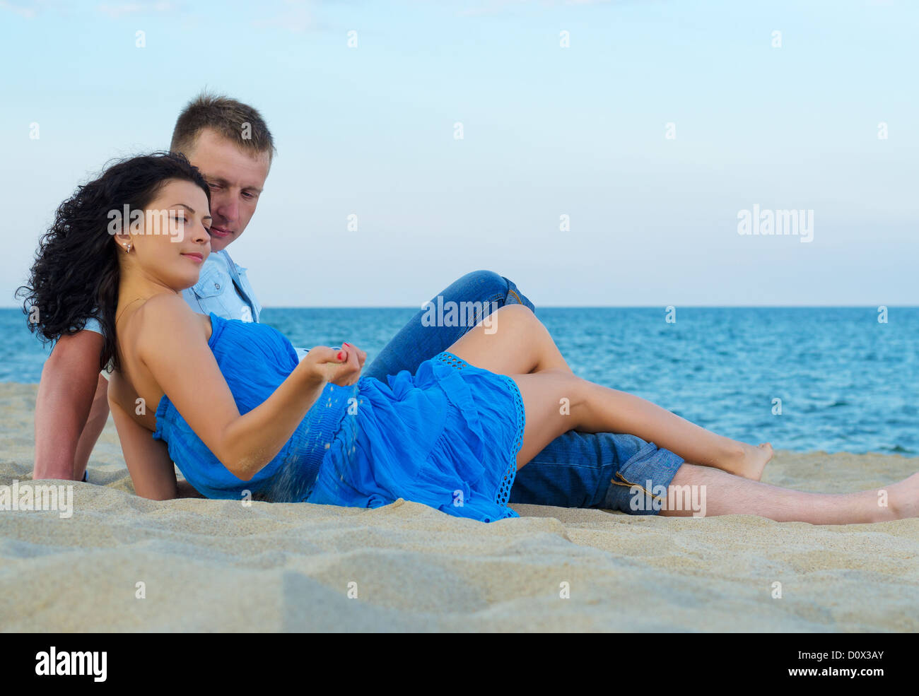 Happy couple enjoying on beautiful sandy beach by the sea Stock Photo
