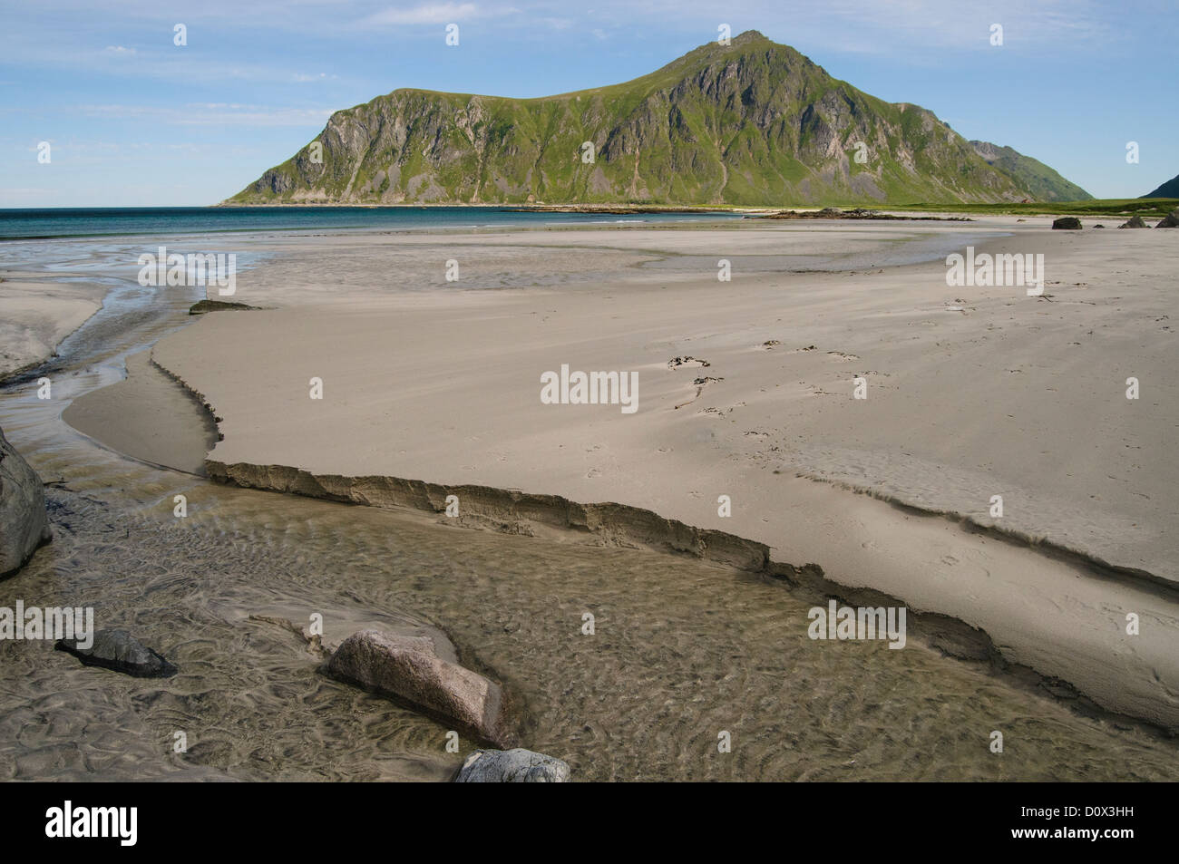 Sandy beach at low tide with typical mountain in the sea, Lofoten, Norway Stock Photo