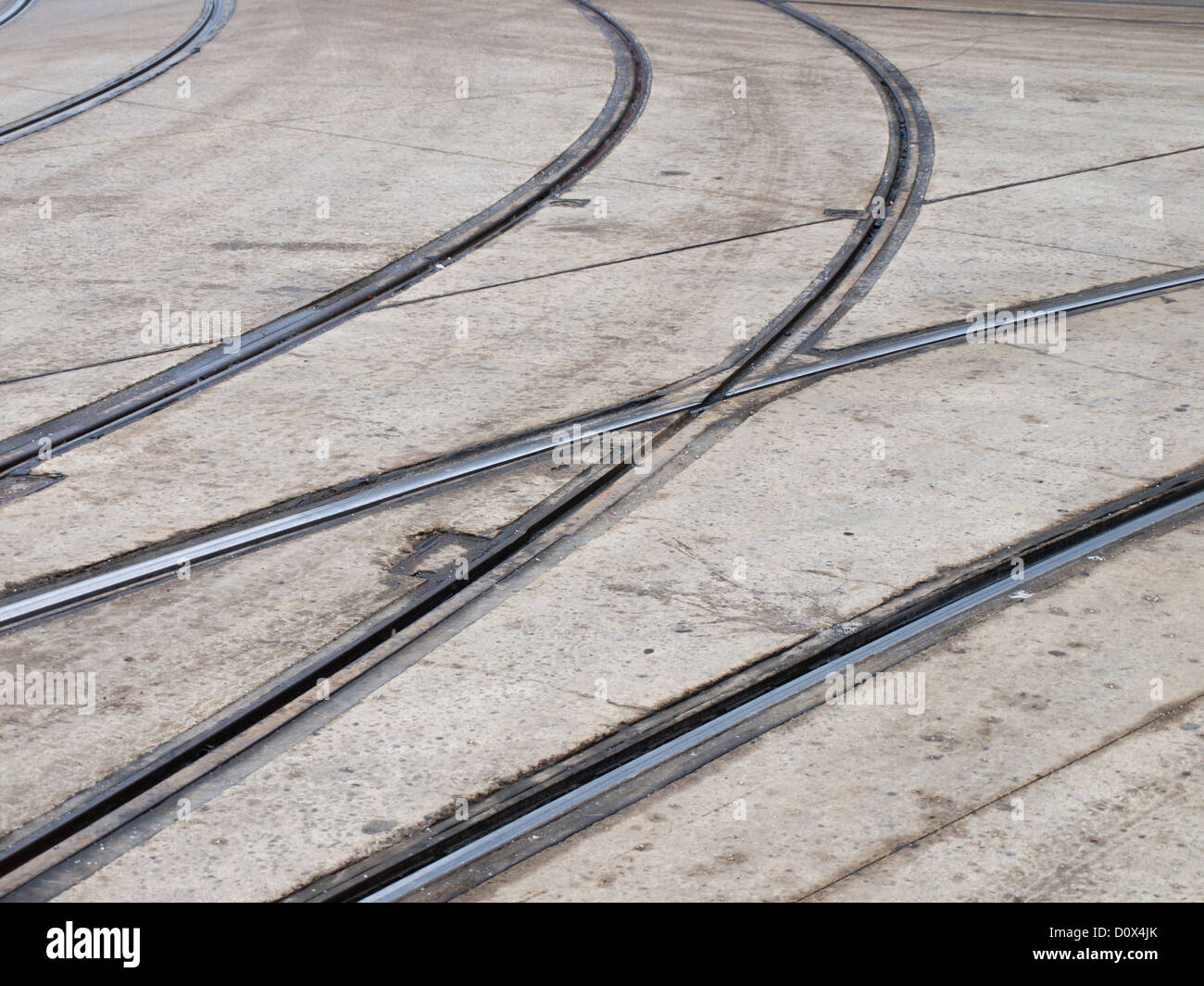 Intersecting tram tracks making patters in the concrete road surface in Oslo Norway Stock Photo