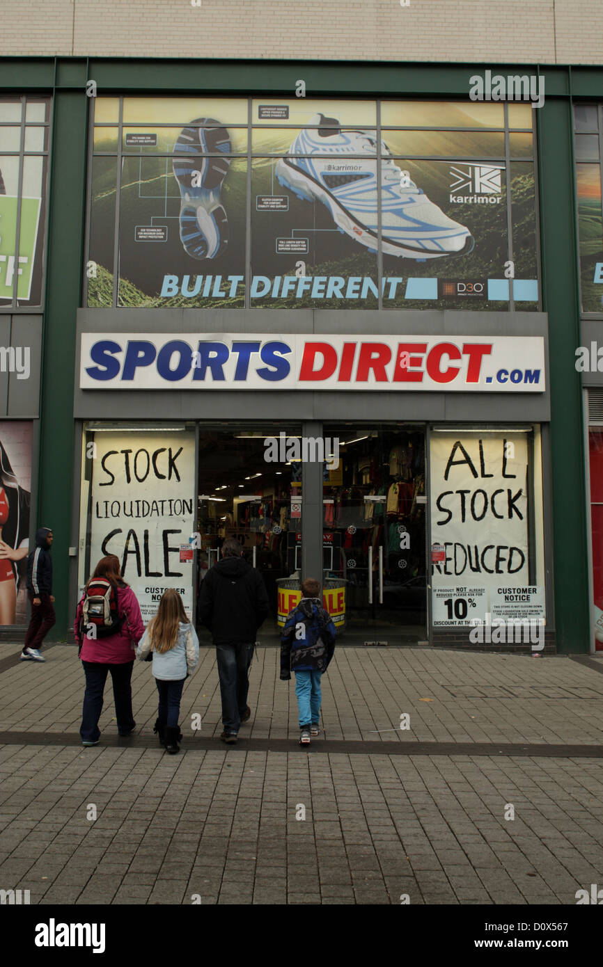 Sports Direct retail shop showing signs wicih say 'stock liquidation sale' Birmingham UK Stock Photo