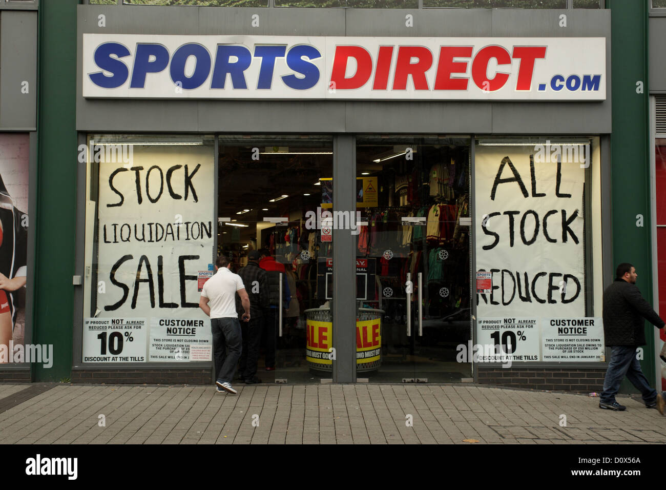 Sports Direct retail shop showing signs wicih say 'stock liquidation sale' Birmingham UK Stock Photo