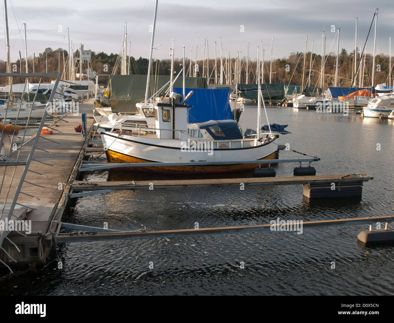 Fishing boat and pleasure crafts in marina, winter mooring Oslo Norway