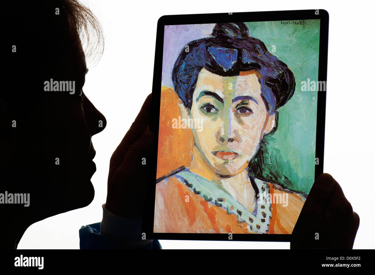 silhouette of woman with portrait of Madam Matisse 'The Green Line' 1905 Henri Matisse on digital tablet Stock Photo