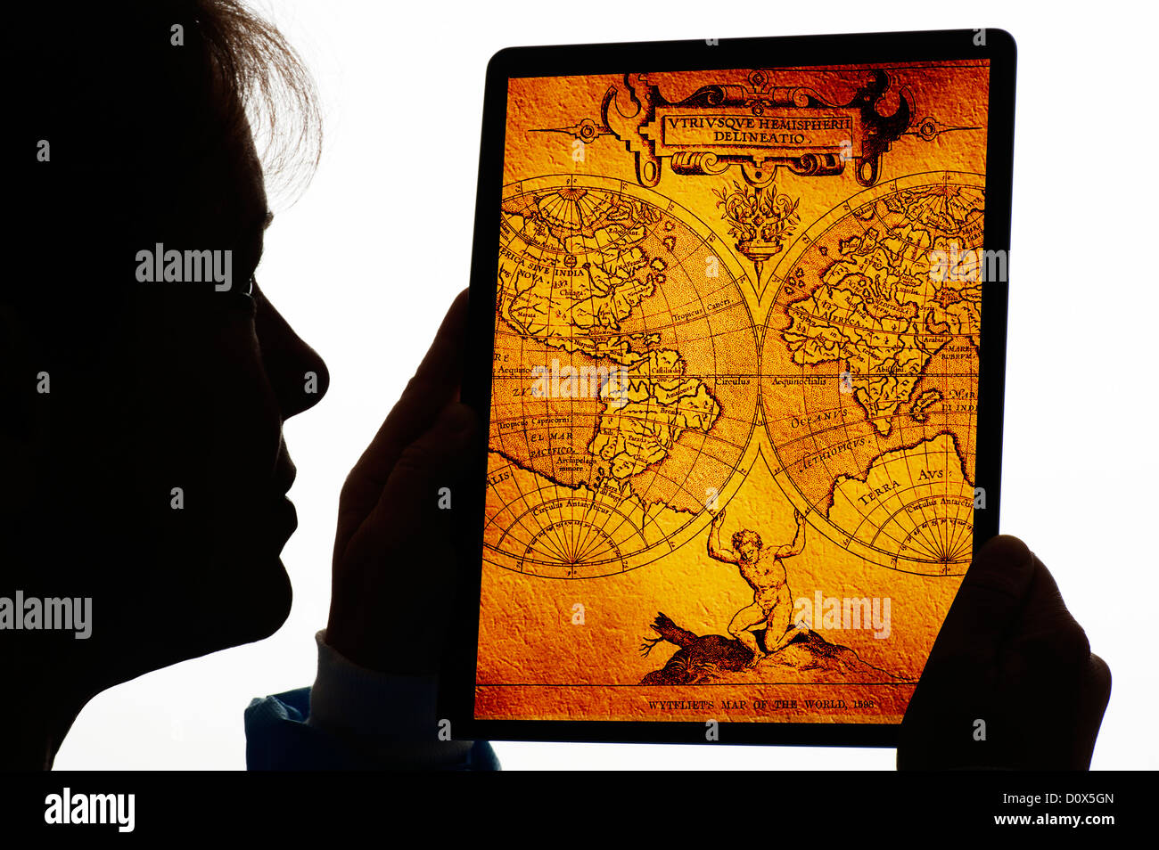 silhouette of woman with old map on digital tablet Stock Photo
