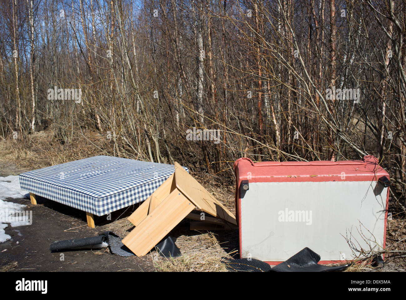 Sofa , bed and other furniture dumped into the forest , Finland Stock Photo