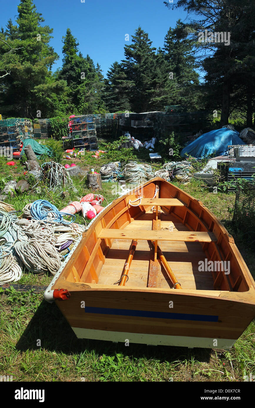 A rowboat, rope, and lobster traps amid trees on Monhegan Island, Maine Stock Photo