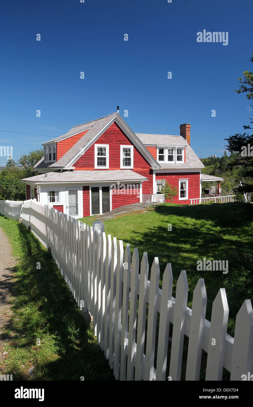 A red home and white picket fence on Monhegan Island, Maine Stock Photo