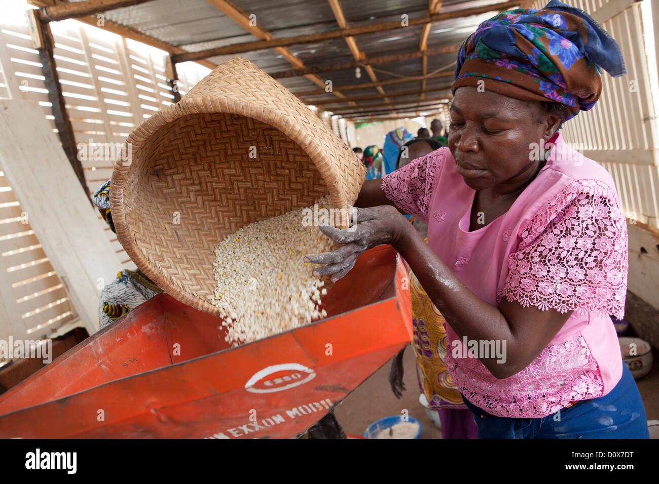 Women grind corn into flour at a mill in Doba, Chad, Africa. Stock Photo
