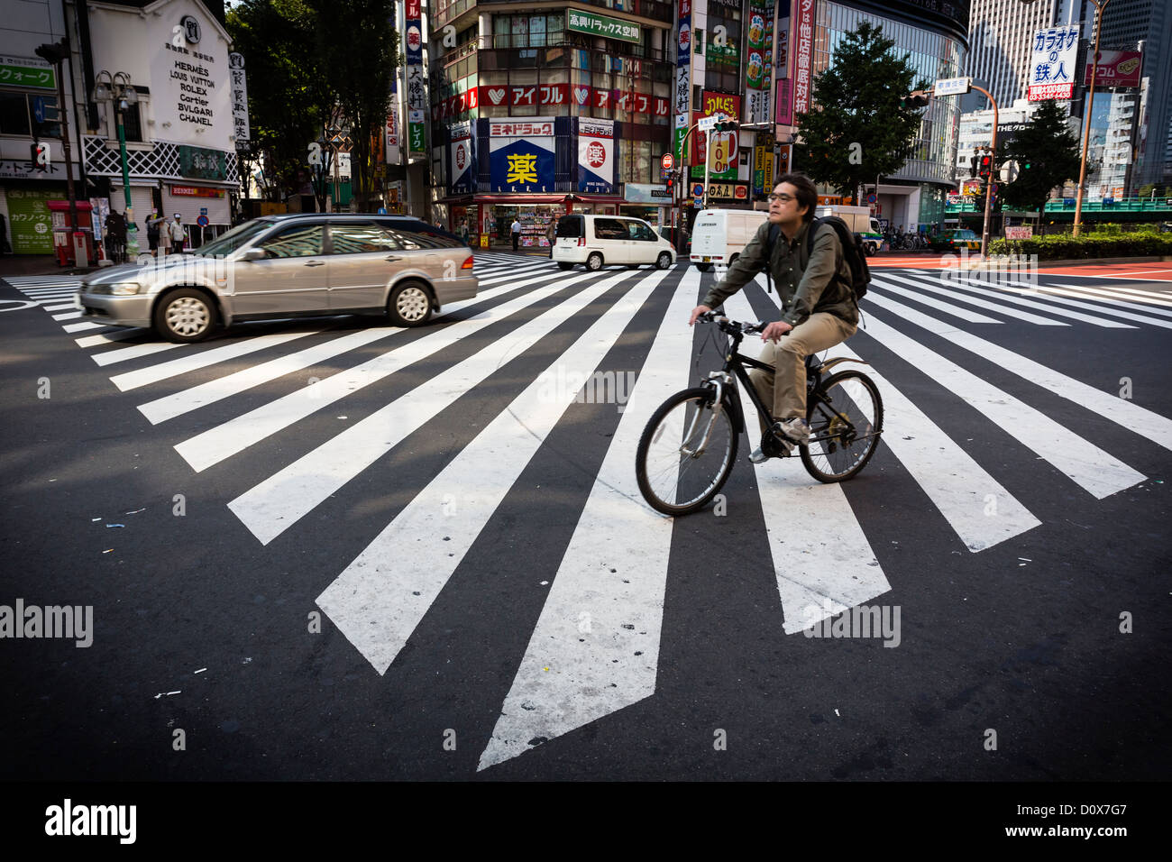 Man Rides A Bike Through A Zebra Crossing In Shinjuku Stock Photo Alamy