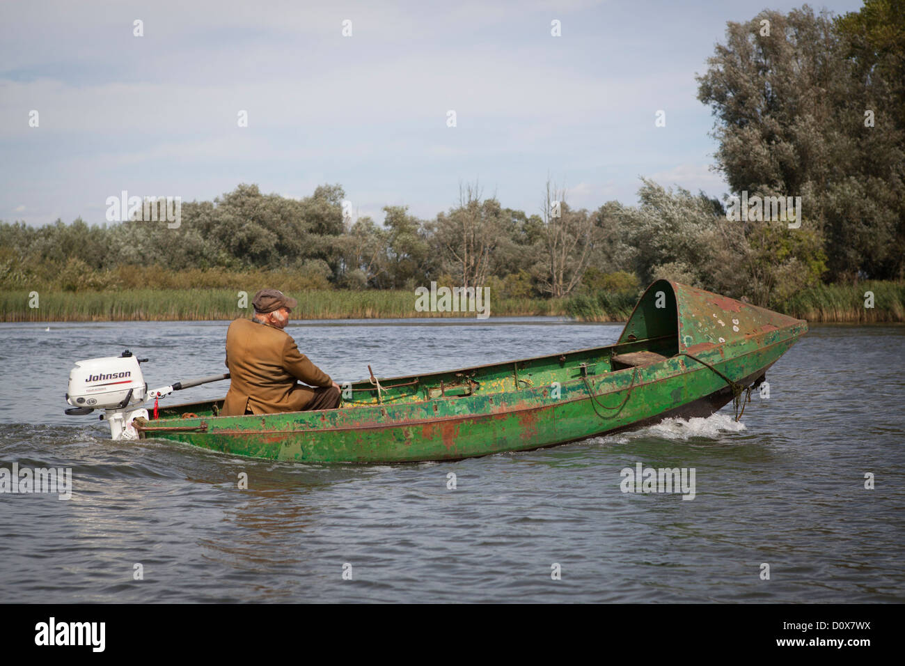 Local fisherman in an old boat on the river in National Park de Biesbosch in the Netherlands Stock Photo