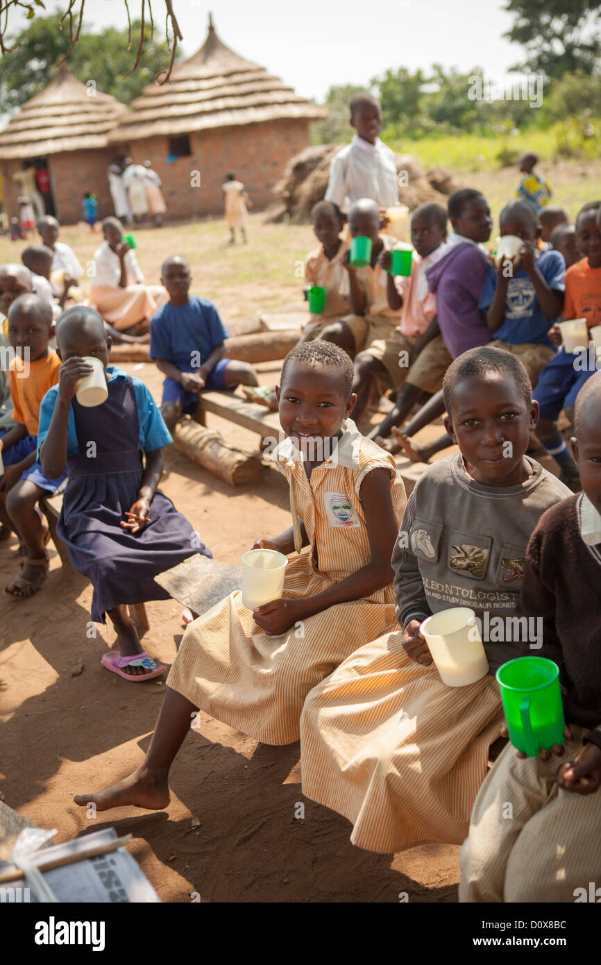 Students receive porridge at break time a school in Amuria, Uganda, East Africa. Stock Photo