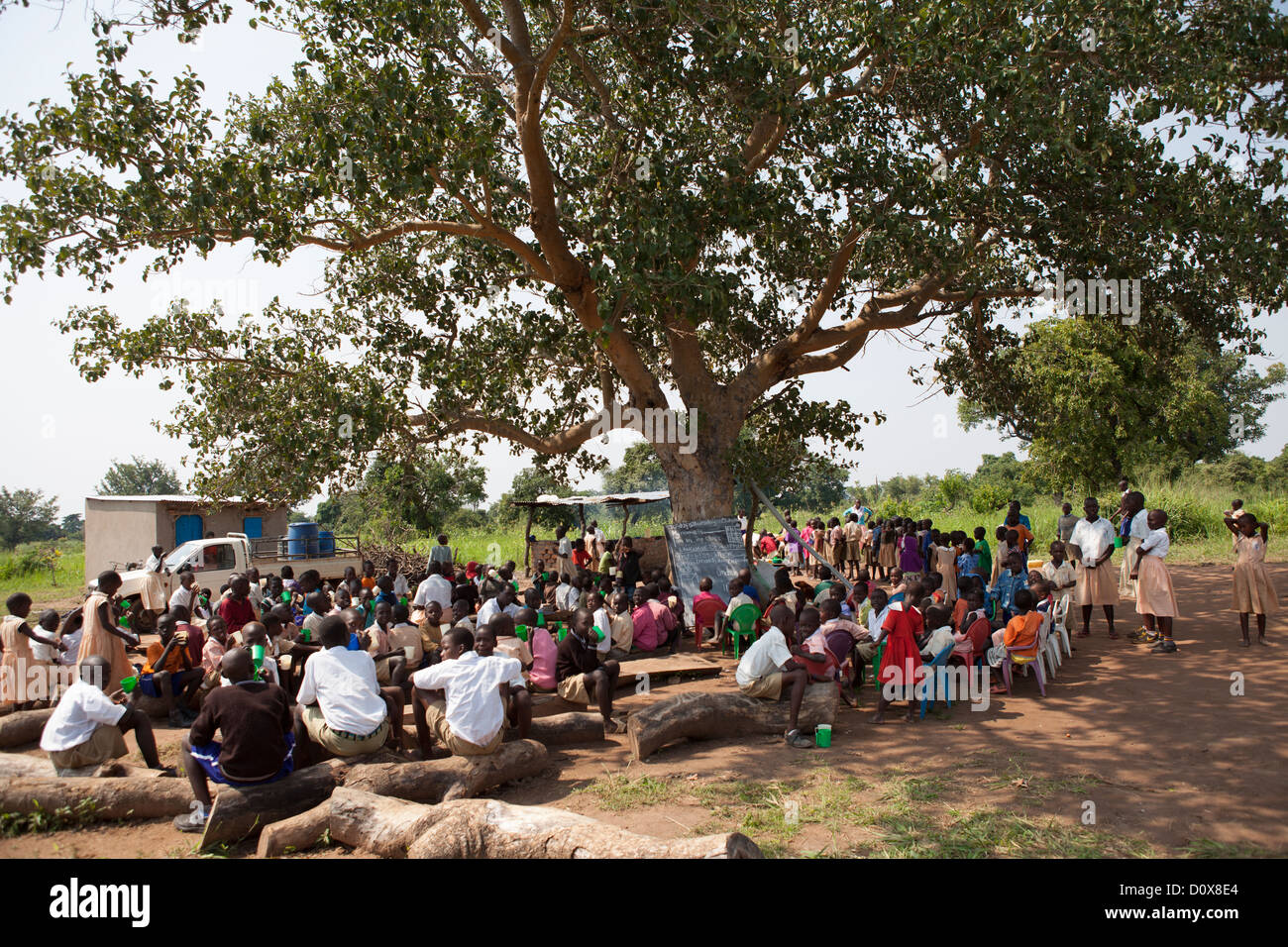 Students receive porridge at break time a school in Amuria, Uganda, East Africa. Stock Photo