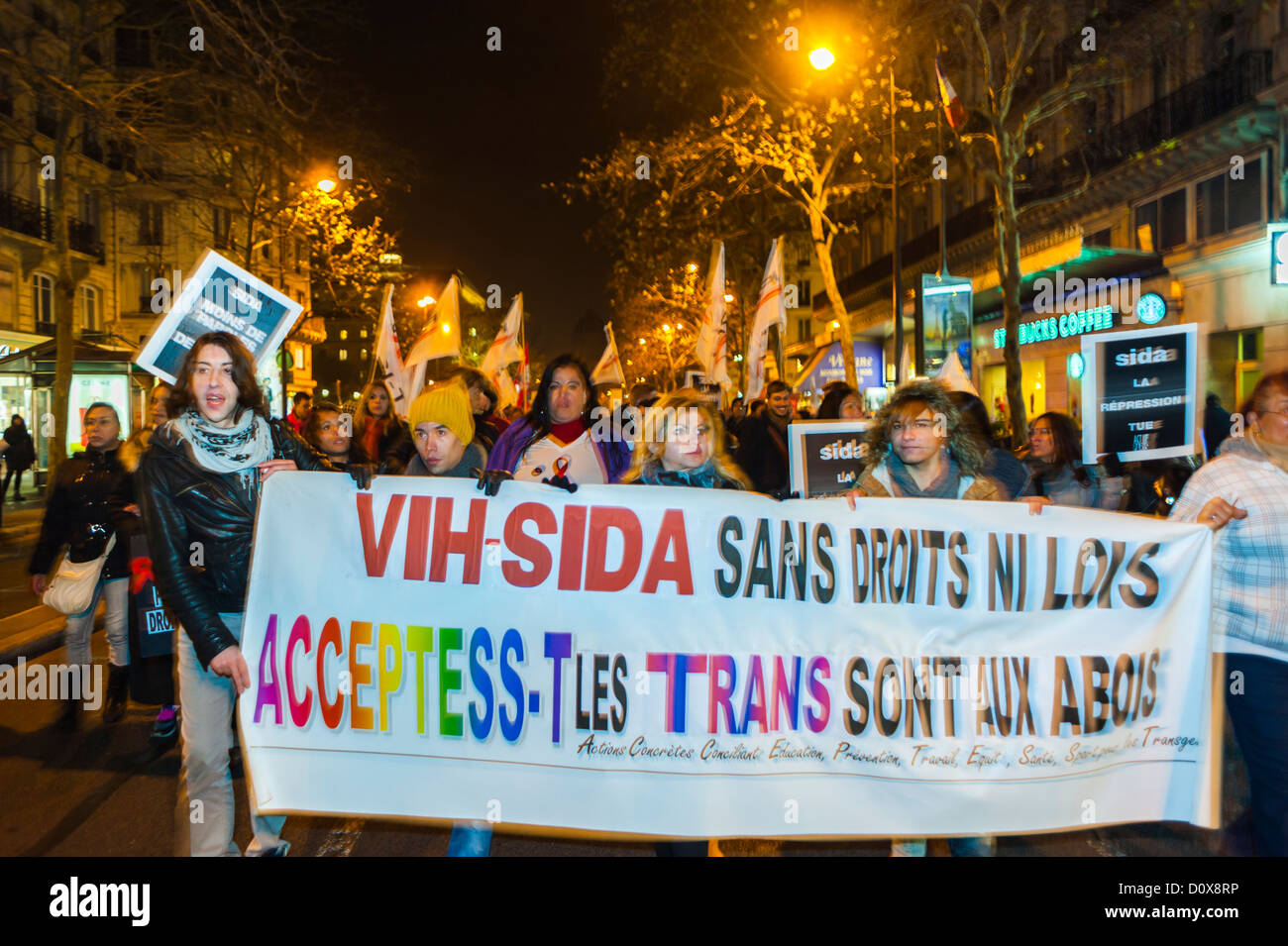 Paris, France, AIDS Trans Activists of Acceptess-T, a transgender rights  Association Public Demonstration, for December 1, World AIDS Day Events, trans people Carrying Protest Signs on street at night, aids campaign, homophobia transphobia, transgender support Stock Photo