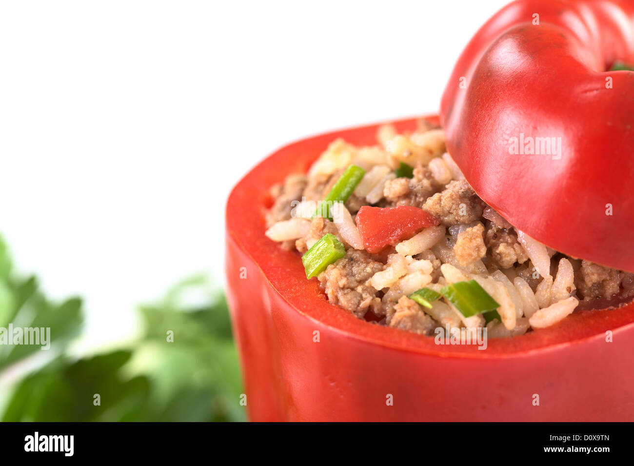Unbaked stuffed red bell pepper filled with ground meat, onion, rice, tomato and green onion Stock Photo