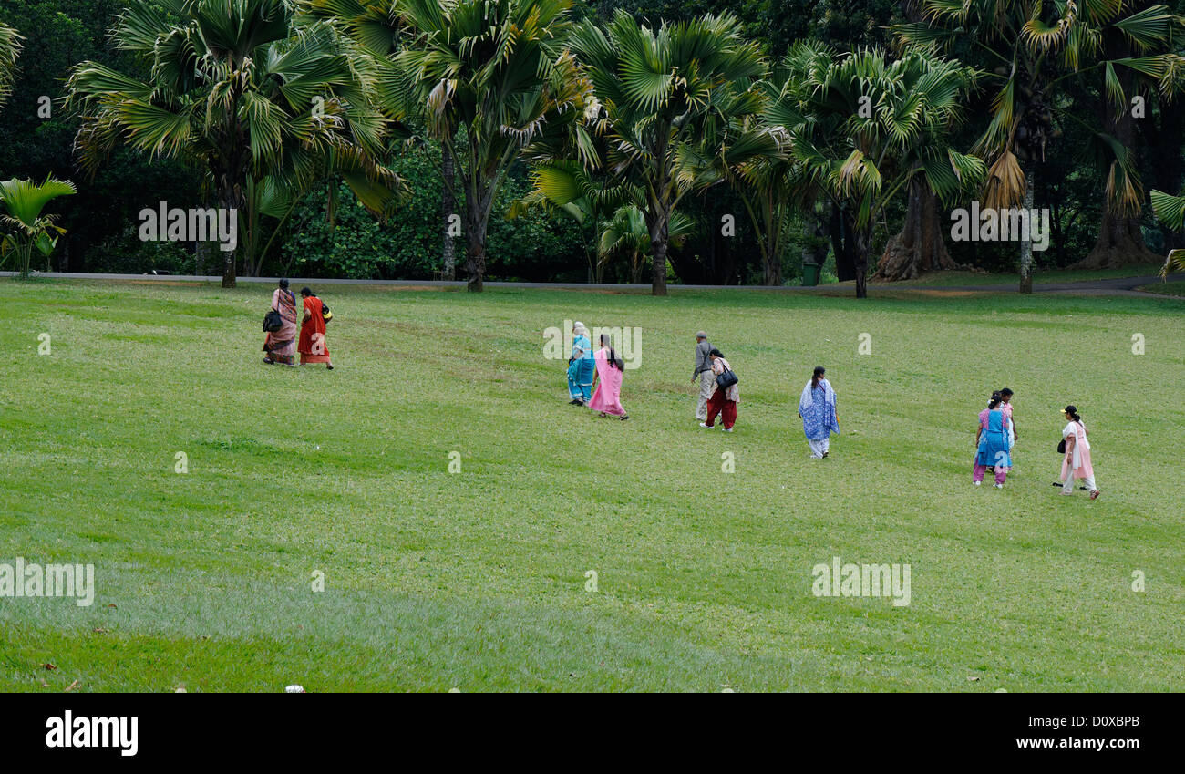 Group of Sri Lankan women walking out from the Botanical Gardens, Kandy, in traditional saris. Stock Photo