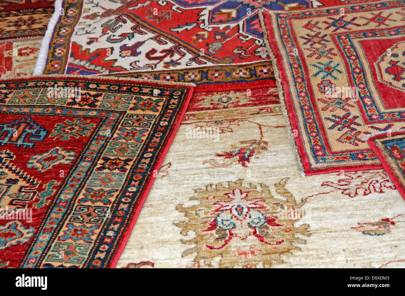 collection of antique oriental carpets expensive on display in the antiques boutique Stock Photo