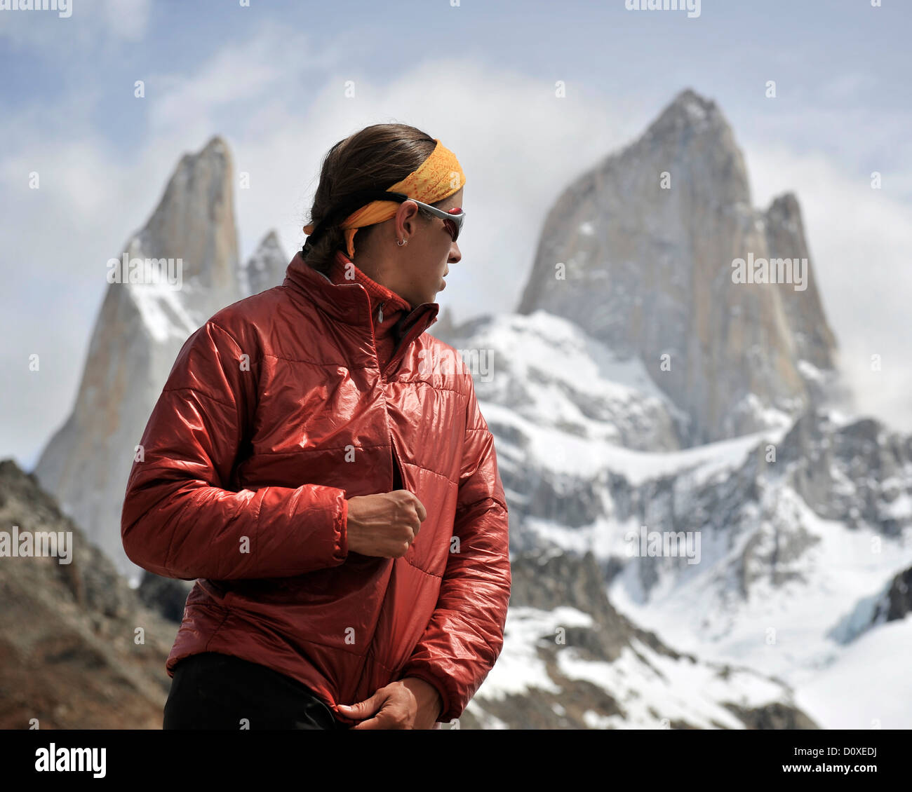 Woman zips her jacket in front of Monte Fitz Roy in Los Glaciares National Park, El Chalten, Argentina Stock Photo