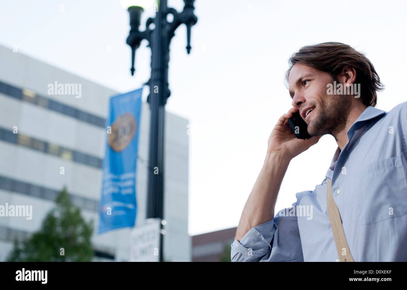 Man on his way to work, using cellphone Stock Photo