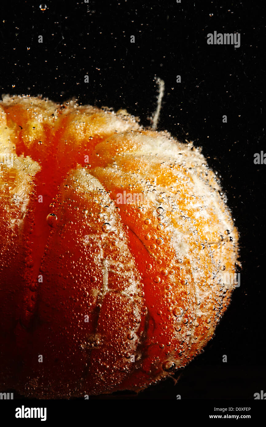 Peeled mandarine in bubbles Stock Photo