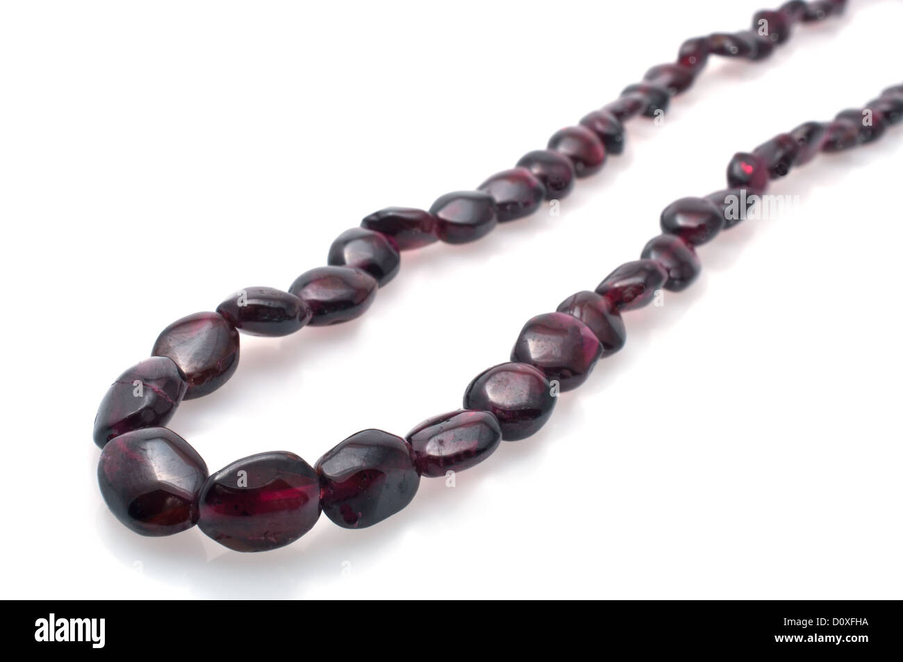 Red-beaded necklace on  a white background Stock Photo