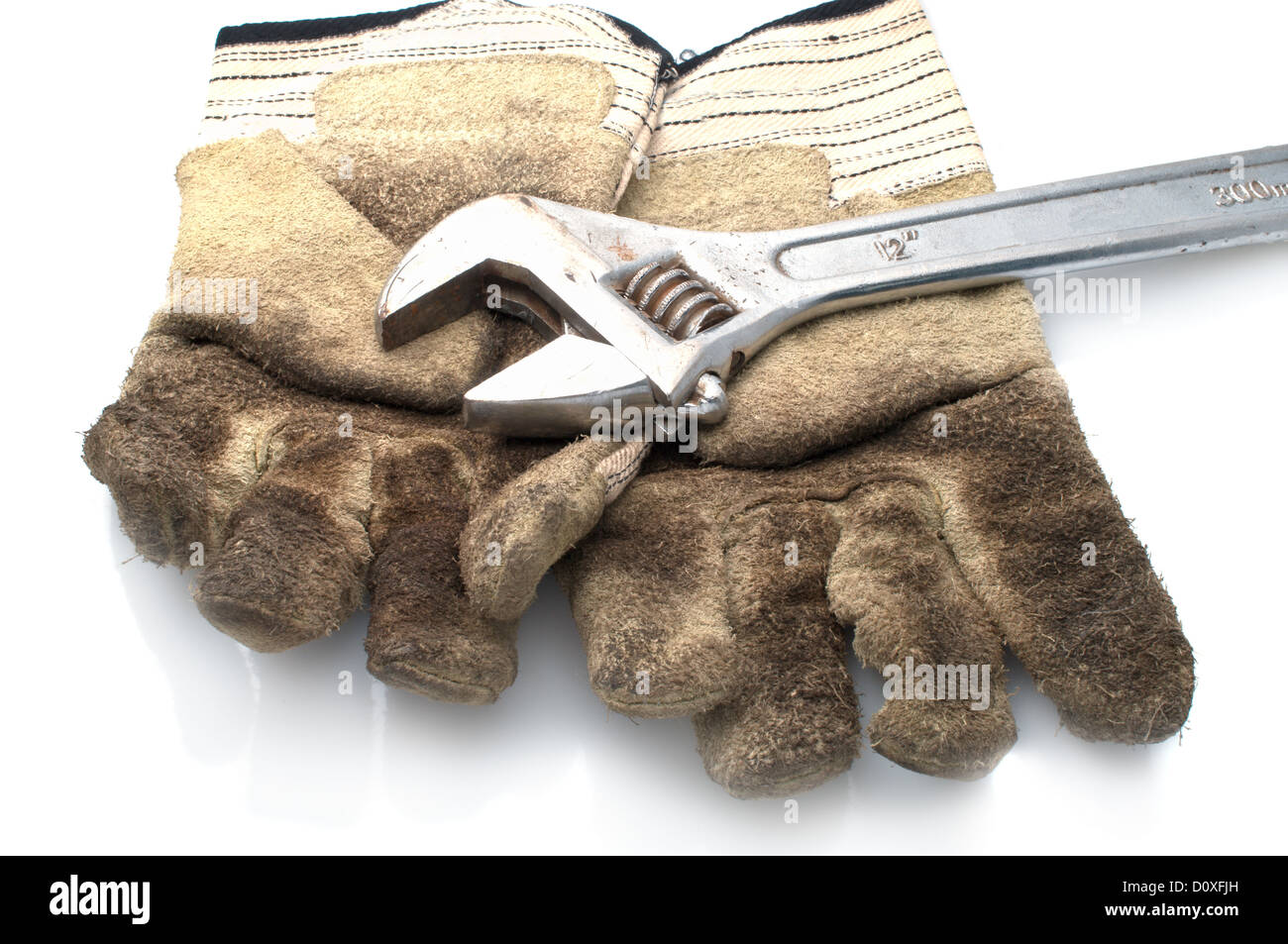 Dirty leather gloves and monkey wrench Stock Photo Alamy