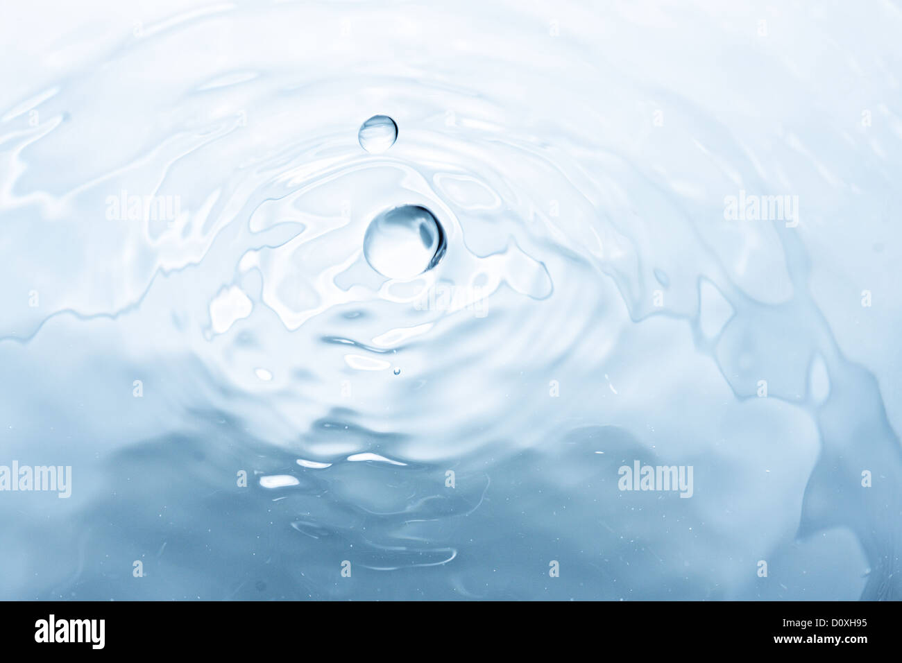Droplets flying over water Stock Photo