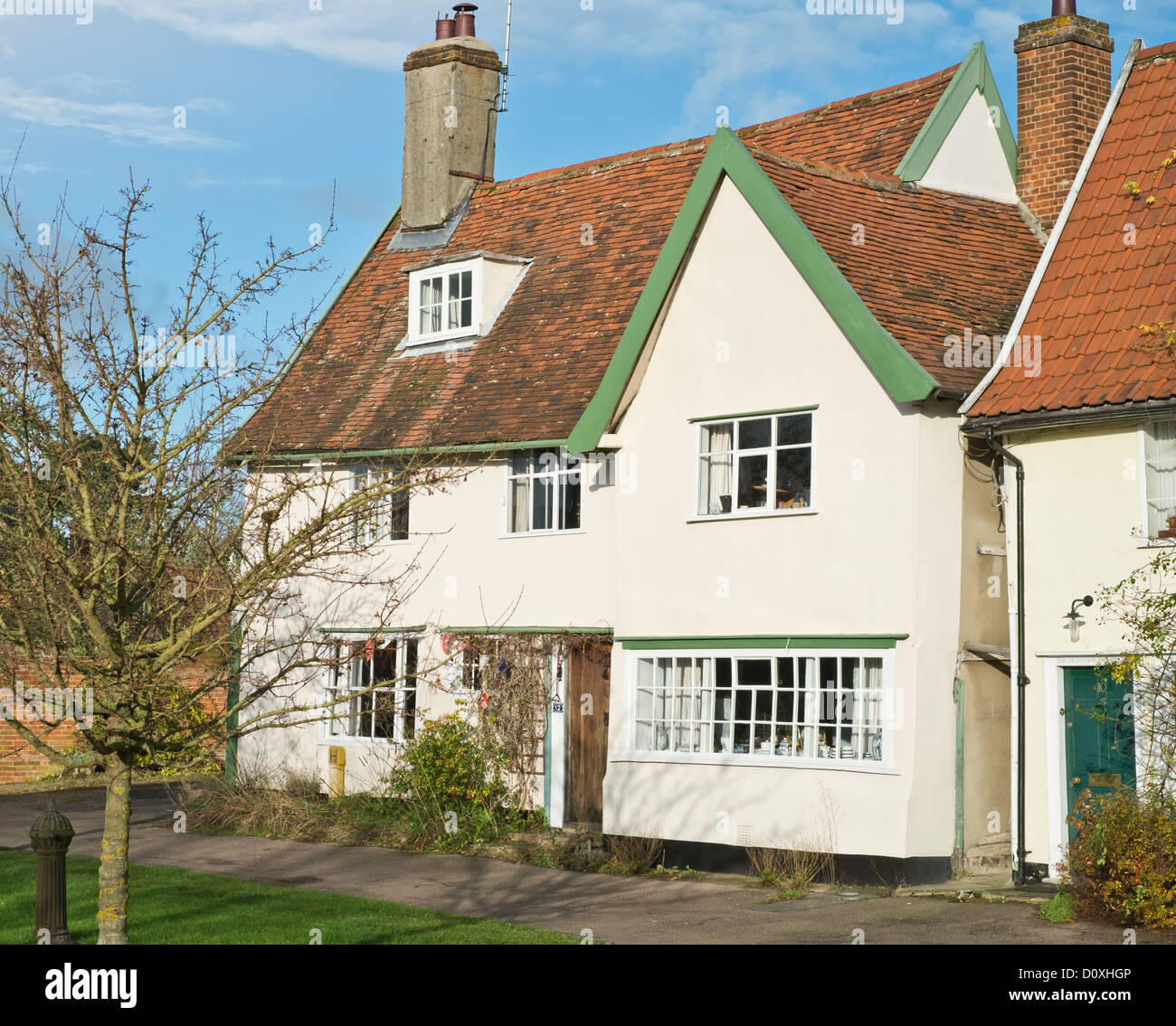 A painted brick house found along the streets of Debenham in Suffolk. The age of the building is indicated by the leaning walls. Stock Photo