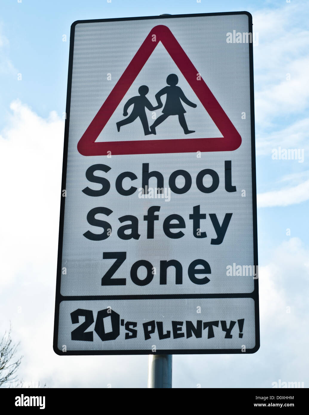 A traffic sign that warns of the 'school safety zone' and instructs driver's to keep to maximum of 20 miles per hour. Stock Photo
