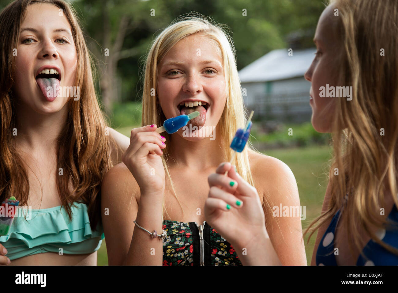 Girls eating ice lollies Stock Photo