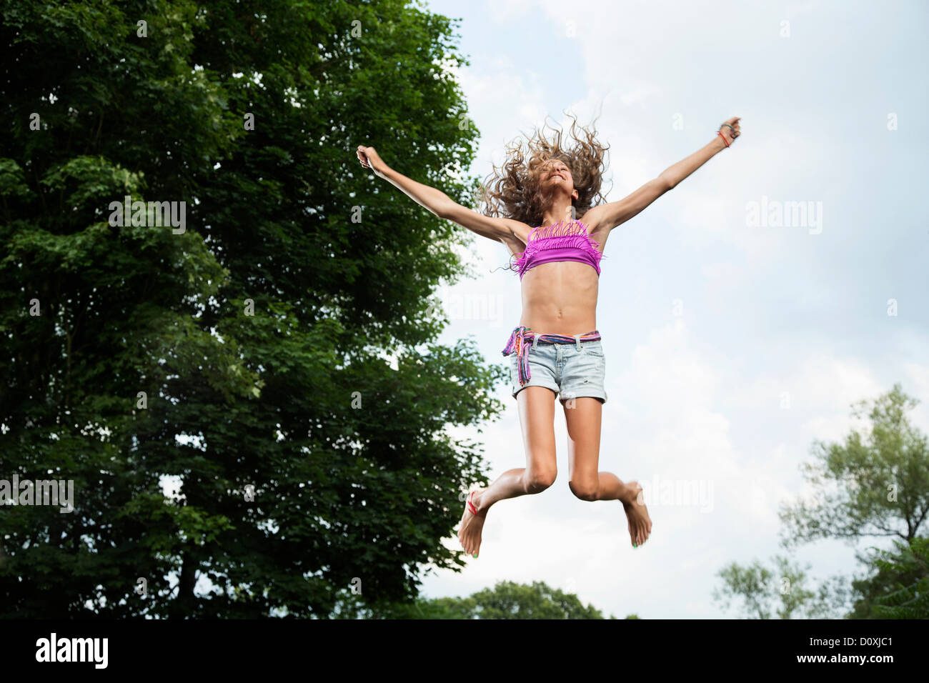 Girl on trampoline Stock Photo Alamy